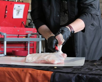sheryl valentine teaching pork loin prep at outdoor chef class