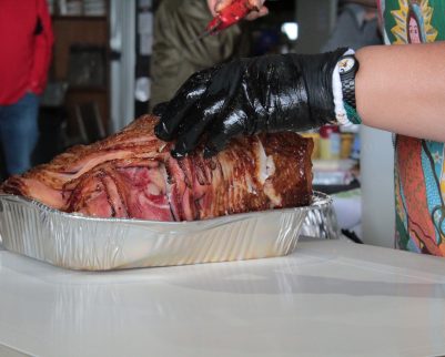 smoked ham being sliced at cooking class