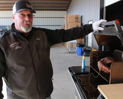 tony valentine showing the smoked turkey on a timberline grill