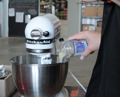 pouring craigs APS into a kitchenaid mixture